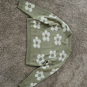 white flowers with a light green background sweater